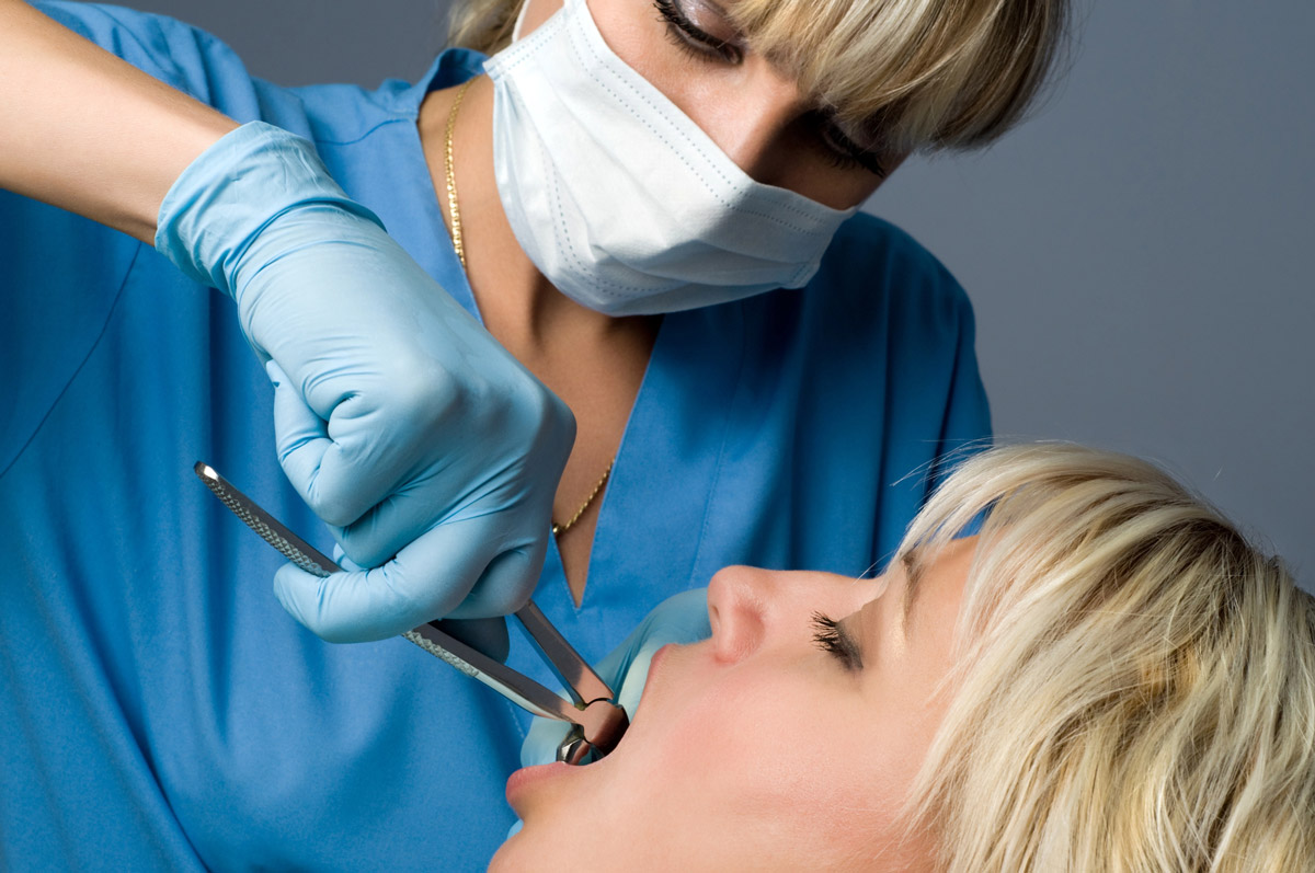 Dentist performing emergency dental treatment on patient